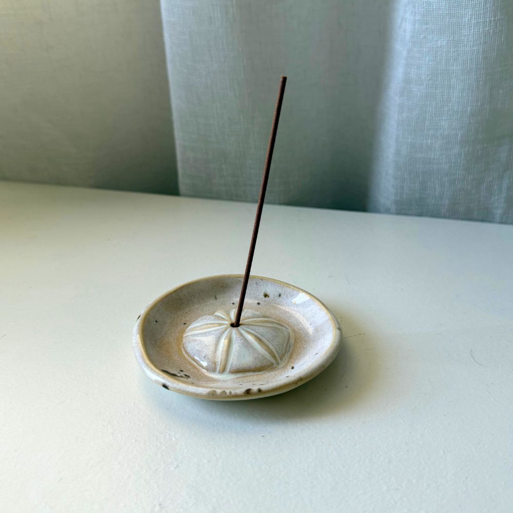 Ceramic incense burner with a single incense stick on a light surface. Sunshine Pot-Tree